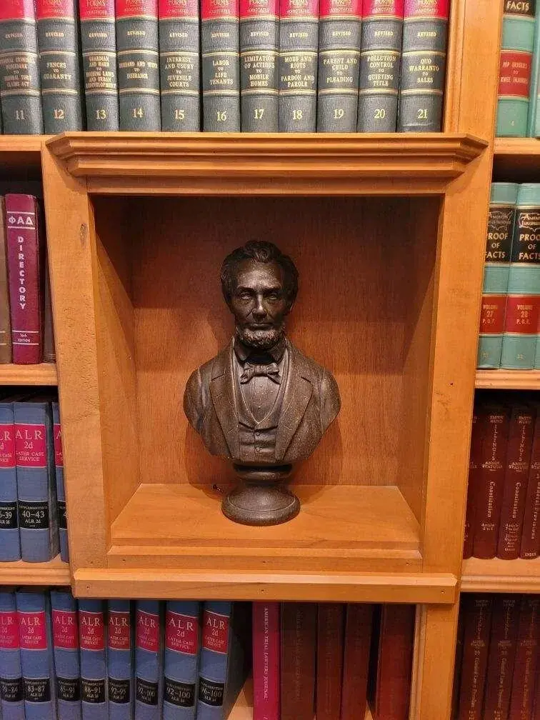 Bust of Abraham Lincoln nestled among legal volumes